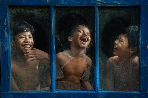 Happy behind broken window