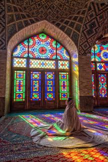 prayer in church colourful glass