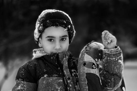 A Boy Playing with Snow